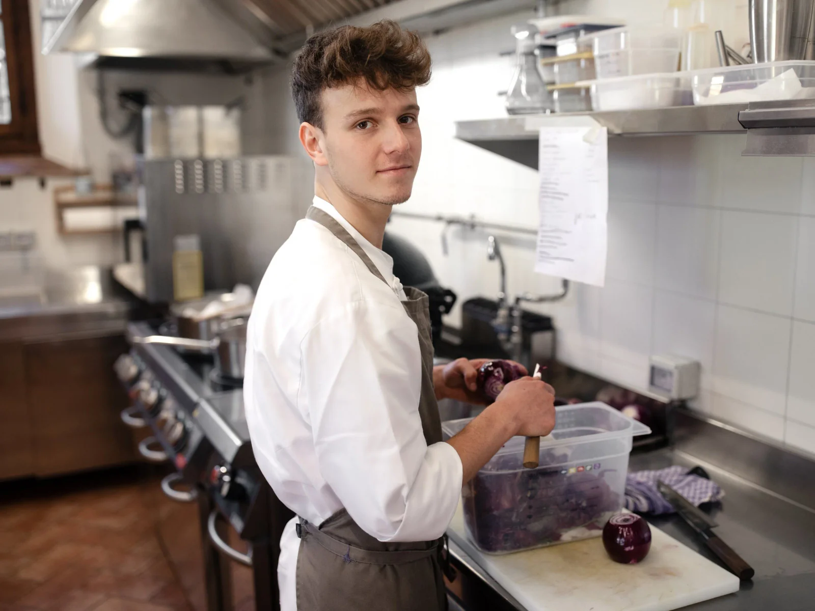 Line cook at the station during prep